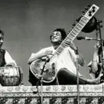 Indian classical musician playing sitar in Raag Yaman default
